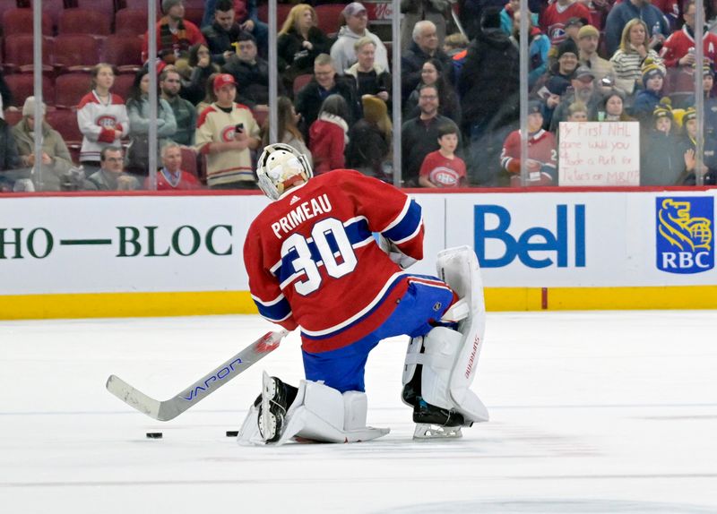 Jan 11, 2024; Montreal, Quebec, CAN; Montreal Canadiens goalie Cayden Primeau (30) stretches during the warmup period before the game against the San Jose Sharks at the Bell Centre. Mandatory Credit: Eric Bolte-USA TODAY Sports