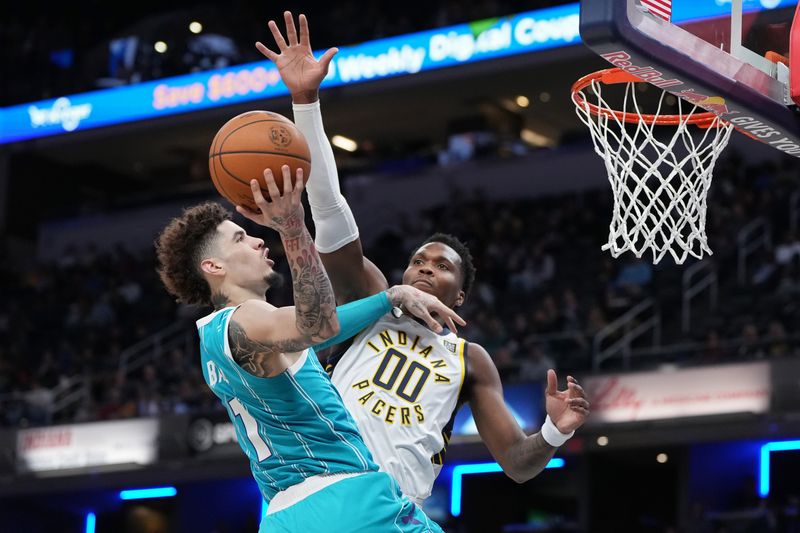 INDIANAPOLIS, INDIANA - OCTOBER 17: LaMelo Ball #1 of the Charlotte Hornets attempts a shot while being guarded by Bennedict Mathurin #00 of the Indiana Pacers in the first quarter during a preseason game at Gainbridge Fieldhouse on October 17, 2024 in Indianapolis, Indiana. NOTE TO USER: User expressly acknowledges and agrees that, by downloading and or using this photograph, User is consenting to the terms and conditions of the Getty Images License Agreement. (Photo by Dylan Buell/Getty Images)