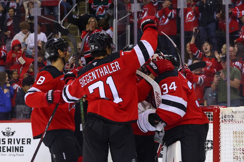 Oct 14, 2024; Newark, New Jersey, USA; The New Jersey Devils celebrate their 3-0 win over the Utah Hockey Club at Prudential Center. Mandatory Credit: Ed Mulholland-Imagn Images