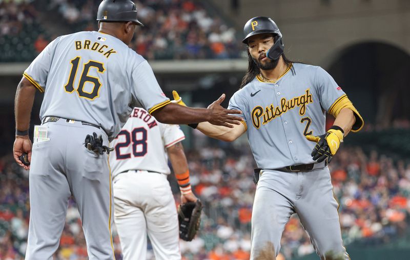 Jul 30, 2024; Houston, Texas, USA; Pittsburgh Pirates first baseman Connor Joe (2) celebrates with first base coach Tarrik Brock (16) after a single during the eighth inning against the Houston Astros at Minute Maid Park. Mandatory Credit: Troy Taormina-USA TODAY Sports