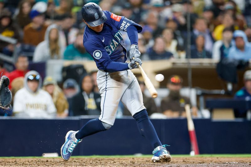 May 17, 2025; San Diego, California, USA; Seattle Mariners second baseman Dylan Moore (25) hits a two run single during the ninth inning against the San Diego Padres  at Petco Park. Mandatory Credit: David Frerker-Imagn Images