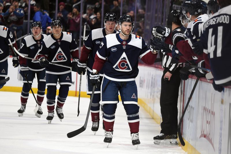 Jan 31, 2025; Denver, Colorado, USA; Colorado Avalanche left wing Jonathan Drouin (27) is congratulated by teammates after a goal during the first period against the St. Louis Blues at Ball Arena. Mandatory Credit: Christopher Hanewinckel-Imagn Images