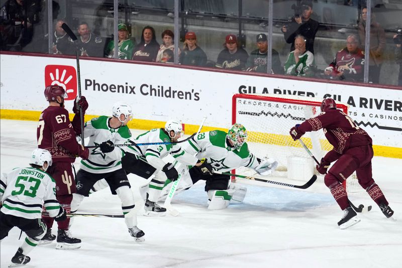 Mar 24, 2024; Tempe, Arizona, USA; Arizona Coyotes center Nick Bjugstad (17) scores against Dallas Stars goaltender Jake Oettinger (29) during the third period at Mullett Arena. Mandatory Credit: Joe Camporeale-USA TODAY Sports