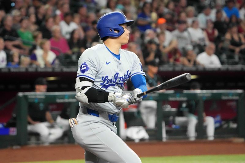 Sep 2, 2024; Phoenix, Arizona, USA; Los Angeles Dodgers two-way player Shohei Ohtani (17) hits a single against the Arizona Diamondbacks during the first inning at Chase Field. Mandatory Credit: Joe Camporeale-USA TODAY Sports