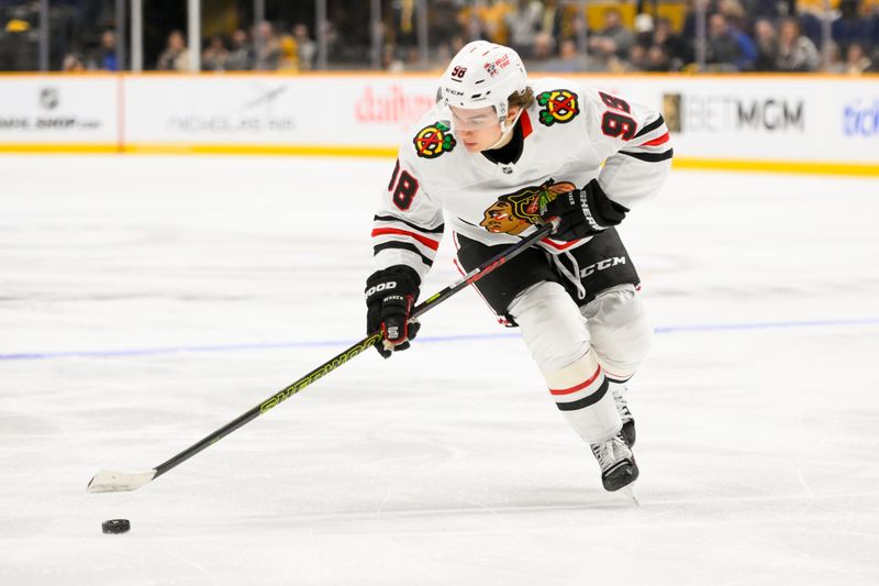 Jan 16, 2025; Nashville, Tennessee, USA;  Chicago Blackhawks center Connor Bedard (98) skates with the puck against the Nashville Predators during the second period at Bridgestone Arena. Mandatory Credit: Steve Roberts-Imagn Images