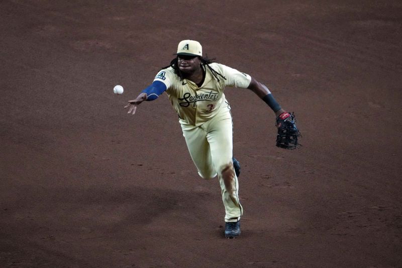 Aug 13, 2024; Phoenix, Arizona, USA; Arizona Diamondbacks first base Josh Bell (36) flips to first base against the Colorado Rockies during the sixth inning at Chase Field. Mandatory Credit: Joe Camporeale-USA TODAY Sports