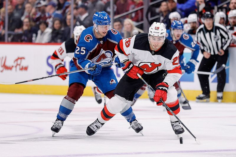 Nov 7, 2023; Denver, Colorado, USA; New Jersey Devils right wing Timo Meier (28) controls the puck ahead of Colorado Avalanche right wing Logan O'Connor (25) in the third period at Ball Arena. Mandatory Credit: Isaiah J. Downing-USA TODAY Sports