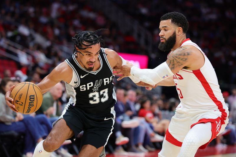 HOUSTON, TEXAS - OCTOBER 17: Tre Jones #33 of the San Antonio Spurs drives against Fred VanVleet #5 of the Houston Rockets during the second half of a preseason game at Toyota Center on October 17, 2024 in Houston, Texas. NOTE TO USER: User expressly acknowledges and agrees that, by downloading and or using this photograph, User is consenting to the terms and conditions of the Getty Images License Agreement. (Photo by Alex Slitz/Getty Images)