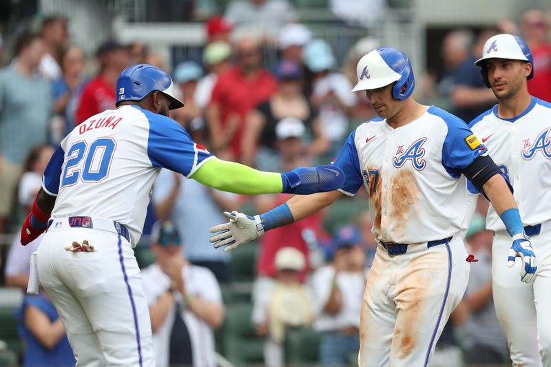 Jun 15, 2024; Cumberland, Georgia, USA; Atlanta Braves third baseman Austin Riley (27) celebrates his home run with Atlanta Braves designated hitter Marcell Ozuna (20) against the Tampa Bay Rays during the seventh inning at Truist Park. Mandatory Credit: Mady Mertens-USA TODAY Sports