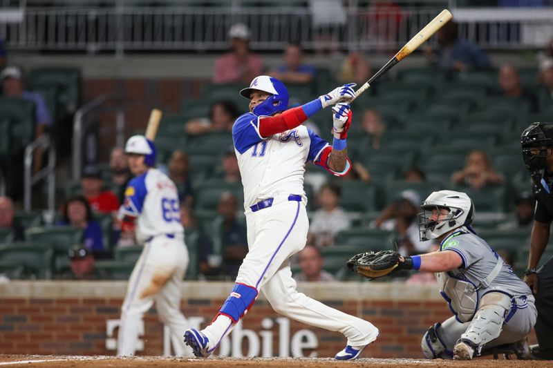 Sep 7, 2024; Atlanta, Georgia, USA; Atlanta Braves shortstop Orlando Arcia (11) hits a single against the Toronto Blue Jays in the ninth inning at Truist Park. Mandatory Credit: Brett Davis-Imagn Images
