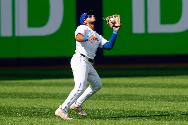 Jul 28, 2024; Toronto, Ontario, CAN; Toronto Blue Jays shortstop Leo Jimenez (49) catches a pop up from Texas Rangers shortstop Corey Seager (not pictured) during the ninth inning at Rogers Centre. Mandatory Credit: John E. Sokolowski-USA TODAY Sports