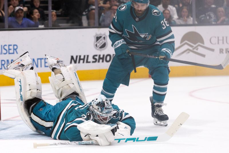 Mar 19, 2026; San Jose, California, USA; San Jose Sharks goaltender Alex Nedelijkovic (33) dives to get a glove on a loose puck during the first period against the Buffalo Sabres at SAP Center at San Jose. Mandatory Credit: D. Ross Cameron-Imagn Images