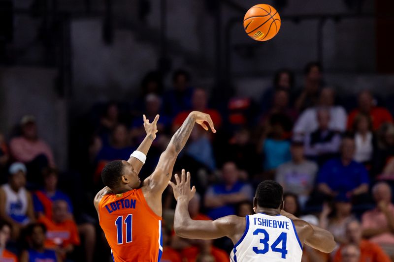 Feb 22, 2023; Gainesville, Florida, USA; Florida Gators guard Kyle Lofton (11) shoots over Kentucky Wildcats forward Oscar Tshiebwe (34) during the second half at Exactech Arena at the Stephen C. O'Connell Center. Mandatory Credit: Matt Pendleton-USA TODAY Sports