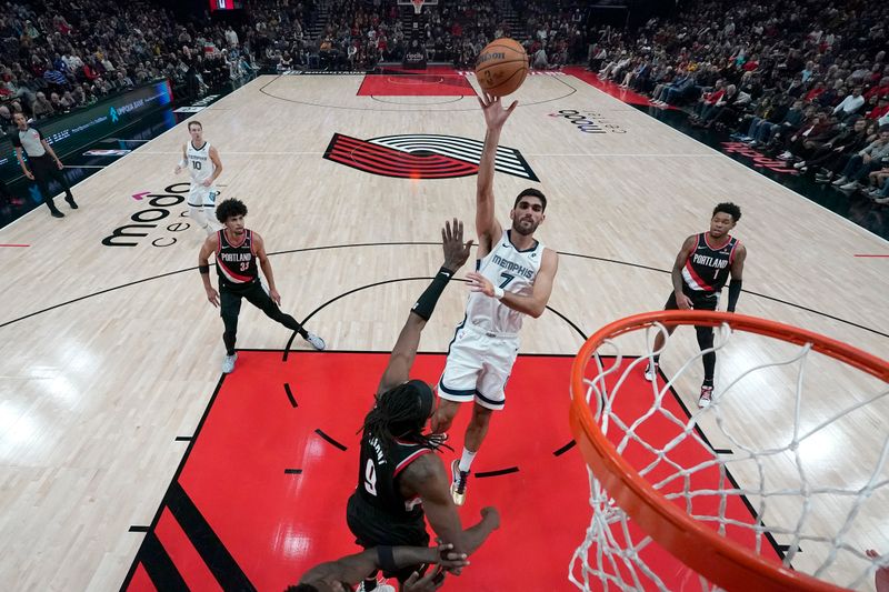 PORTLAND, OREGON - NOVEMBER 10: Santi Aldama #7 of the Memphis Grizzlies shoots the ball over Jerami Grant #9 of the Portland Trail Blazers during the first half at Moda Center on November 10, 2024 in Portland, Oregon. NOTE TO USER: User expressly acknowledges and agrees that, by downloading and or using this photograph, User is consenting to the terms and conditions of the Getty Images License Agreement. (Photo by Soobum Im/Getty Images)