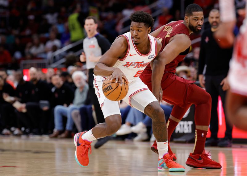 HOUSTON, TEXAS - MARCH 16: Jae'Sean Tate #8 of the Houston Rockets controls the ball around Tristan Thompson #13 of the Cleveland Cavaliers during the first half at Toyota Center on March 16, 2024 in Houston, Texas. NOTE TO USER: User expressly acknowledges and agrees that, by downloading and or using this photograph, User is consenting to the terms and conditions of the Getty Images License Agreement. (Photo by Carmen Mandato/Getty Images)