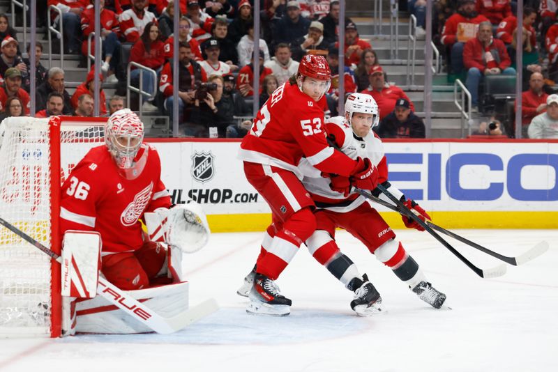 Jan 12, 2026; Detroit, Michigan, USA;  Carolina Hurricanes left wing Nikolaj Ehlers (27) and Detroit Red Wings defenseman Moritz Seider (53) fight for position in front of goaltender John Gibson (36) in the first period at Little Caesars Arena. Mandatory Credit: Rick Osentoski-Imagn Images