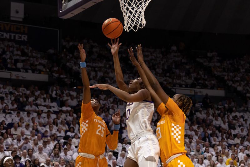 Jan 30, 2023; Baton Rouge, Louisiana, USA;  LSU Lady Tigers forward LaDazhia Williams (0) drives to the basket against Tennessee Lady Vols guard Jordan Horston (25) during the first half at Pete Maravich Assembly Center. Mandatory Credit: Stephen Lew-USA TODAY Sports