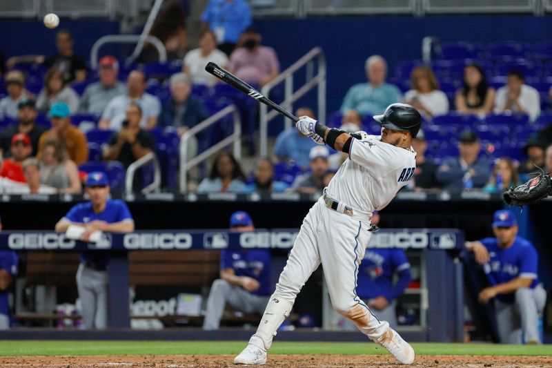 Jun 19, 2023; Miami, Florida, USA; Miami Marlins second baseman Luis Arraez (3) hits a single against the Toronto Blue Jays during the seventh inning at loanDepot Park. Mandatory Credit: Sam Navarro-USA TODAY Sports