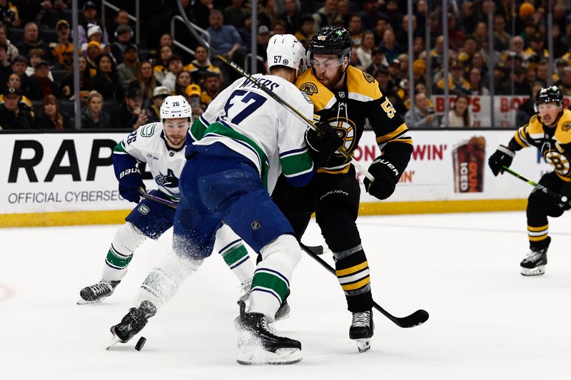 Nov 26, 2024; Boston, Massachusetts, USA; Vancouver Canucks defenseman Tyler Myers (57) tries to keep Boston Bruins right wing Justin Brazeau (55) from a loose puck during the first period at TD Garden. Mandatory Credit: Winslow Townson-Imagn Images