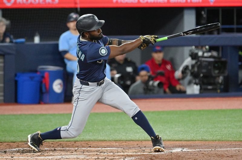Apr 20, 2025; Toronto, Ontario, CAN;  Seattle Mariners left fielder Randy Arozarena (56) hits a two run RBI single against the Toronto Blue Jays in the secon inning at Rogers Centre. Mandatory Credit: Dan Hamilton-Imagn Images