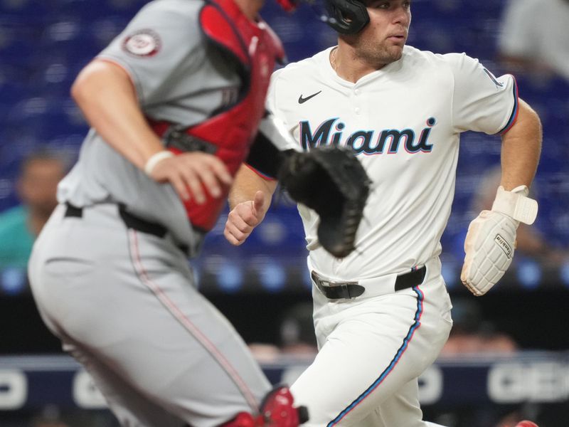 Sep 11, 2025; Miami, Florida, USA;  Miami Marlins center fielder Jakob Marsee (87) scores a run on a base hit in the first inning as Washington Nationals catcher Riley Adams (15) looks on at loanDepot Park. Mandatory Credit: Jim Rassol-Imagn Images