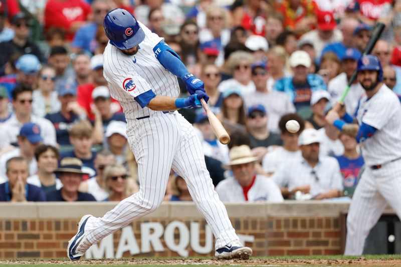 Jul 4, 2024; Chicago, Illinois, USA; Chicago Cubs second baseman David Bote (13) hits a double against the Philadelphia Phillies during the fourth inning at Wrigley Field. Mandatory Credit: Kamil Krzaczynski-USA TODAY Sports