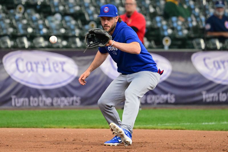 May 29, 2024; Milwaukee, Wisconsin, USA; Chicago Cubs third baseman Patrick Wisdom (16) fields ground balls before game against the Milwaukee Brewers at American Family Field. Mandatory Credit: Benny Sieu-USA TODAY Sports