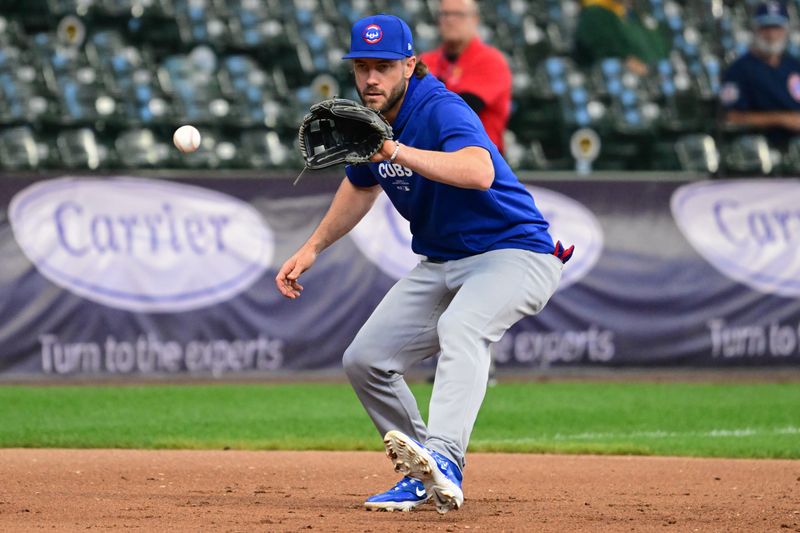 May 29, 2024; Milwaukee, Wisconsin, USA; Chicago Cubs third baseman Patrick Wisdom (16) fields ground balls before game against the Milwaukee Brewers at American Family Field. Mandatory Credit: Benny Sieu-USA TODAY Sports