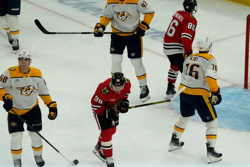 Oct 25, 2024; Chicago, Illinois, USA; Chicago Blackhawks center Connor Bedard (98) scores a goal on Nashville Predators goaltender Juuse Saros (74) during the second period at the United Center. Mandatory Credit: David Banks-Imagn Images