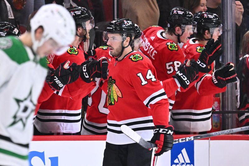 Jan 13, 2024; Chicago, Illinois, USA;  Chicago Blackhawks forward Boris Katchouk (14) celebrates with the bench after scoring a goal in the second period against the Dallas Stars at United Center. Mandatory Credit: Jamie Sabau-USA TODAY Sports