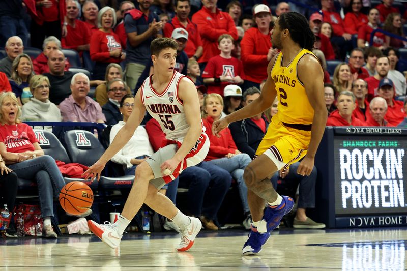 Feb 17, 2024; Tucson, Arizona, USA; Arizona Wildcats guard Conrad Martinez (55) dribbles the ball agaisnt Arizona State Sun Devils guard Braelon Green (2) during the second half at McKale Center. Mandatory Credit: Zachary BonDurant-USA TODAY Sports