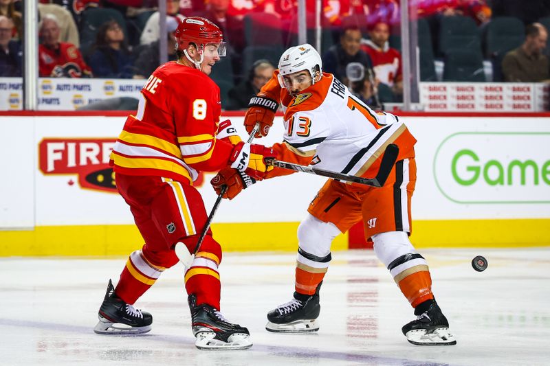 Jan 30, 2025; Calgary, Alberta, CAN; Calgary Flames defenseman Tyson Barrie (8) and Anaheim Ducks center Robby Fabbri (13) battles for the puck during the third period at Scotiabank Saddledome. Mandatory Credit: Sergei Belski-Imagn Images