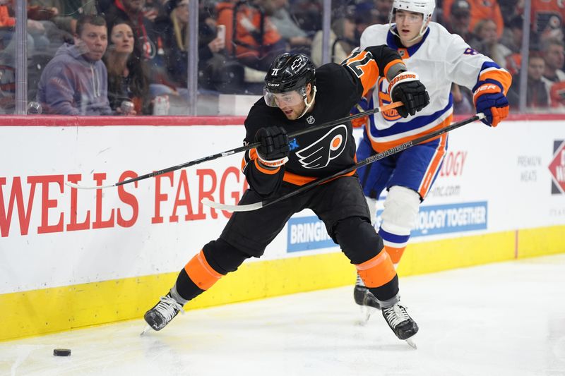 Apr 12, 2025; Philadelphia, Pennsylvania, USA; Philadelphia Flyers right wing Tyson Foerster (71) reaches for the puck against the New York Islanders in the second period at Wells Fargo Center. Mandatory Credit: Kyle Ross-Imagn Images