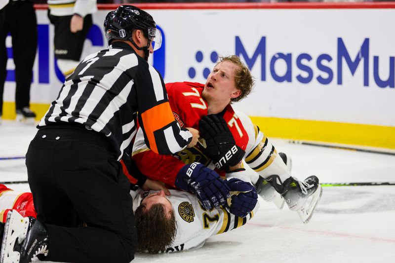 May 8, 2024; Sunrise, Florida, USA; Florida Panthers defenseman Niko Mikkola (77) and Boston Bruins defenseman Charlie McAvoy (73) fight during the third period in game two of the second round of the 2024 Stanley Cup Playoffs at Amerant Bank Arena. Mandatory Credit: Sam Navarro-USA TODAY Sports