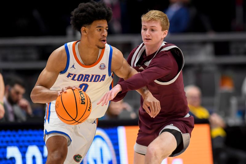 Mar 16, 2024; Nashville, TN, USA;  Texas A&M Aggies guard Hayden Hefner (2) swipes at the ball dribbled by Florida Gators guard Zyon Pullin (0) during the first half at Bridgestone Arena. Mandatory Credit: Steve Roberts-USA TODAY Sports