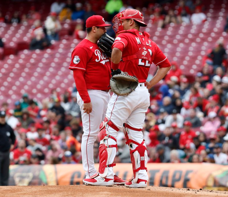 Apr 16, 2023; Cincinnati, Ohio, USA; Cincinnati Reds starting pitcher Luis Cessa (left) and catcher Luke Maile (right) talk at the mound during the first inning against the Philadelphia Phillies at Great American Ball Park. Mandatory Credit: David Kohl-USA TODAY Sports