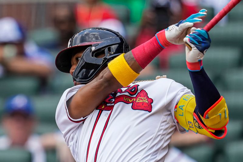 Aug 2, 2023; Cumberland, Georgia, USA; Atlanta Braves right fielder Ronald Acuna Jr. (13) singles against the Los Angeles Angels during the fourth inning at Truist Park. Mandatory Credit: Dale Zanine-USA TODAY Sports