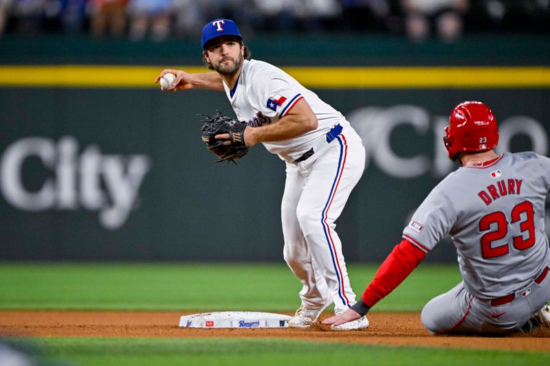 Sep 5, 2024; Arlington, Texas, USA; Texas Rangers shortstop Josh Smith (8) puts out Los Angeles Angels designated hitter Brandon Drury (23) as he turns a double play during the game at Globe Life Field. Mandatory Credit: Jerome Miron-Imagn Images