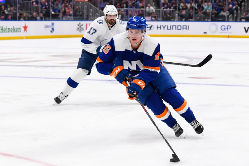 Apr 6, 2023; Elmont, New York, USA; New York Islanders defenseman Sebastian Aho (25) skates with the puck against Tampa Bay Lightning left wing Alex Killorn (17) during the second period at UBS Arena. Mandatory Credit: Dennis Schneidler-USA TODAY Sports