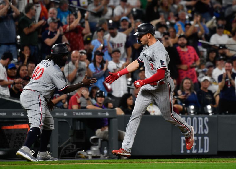 Sep 30, 2023; Denver, Colorado, USA; Minnesota Twins third base coach/outfield coach Tommy Watkins (40) congratulates Minnesota Twins designated hitter Trevor Larnach (9) after his grand slam against the Colorado Rockies in the third inning at Coors Field. Mandatory Credit: John Leyba-USA TODAY Sports