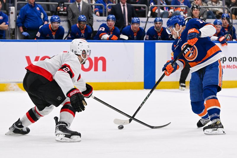 Jan 14, 2025; Elmont, New York, USA;  New York Islanders center Mathew Barzal (13) attempts a shot defended by Ottawa Senators defenseman Artem Zub (2) during the second period at UBS Arena. Mandatory Credit: Dennis Schneidler-Imagn Images