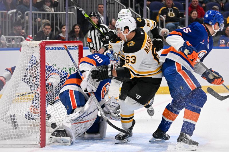 Nov 27, 2024; Elmont, New York, USA;  Boston Bruins left wing Brad Marchand (63) scores a goal past New York Islanders goaltender Ilya Sorokin (30) during the first period at UBS Arena. Mandatory Credit: Dennis Schneidler-Imagn Images