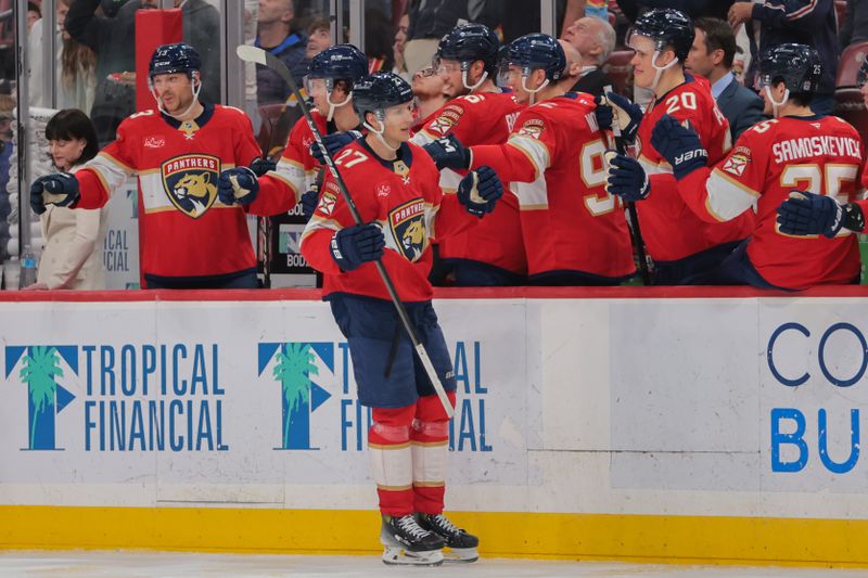 Apr 8, 2025; Sunrise, Florida, USA; Florida Panthers center Eetu Luostarinen (27) celebrates with teammates after scoring against the Toronto Maple Leafs during the third period at Amerant Bank Arena. Mandatory Credit: Sam Navarro-Imagn Images