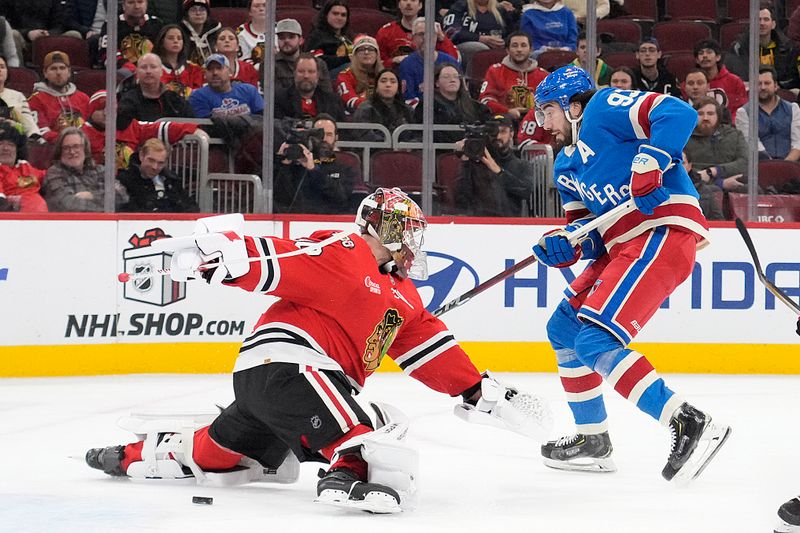Dec 10, 2025; Chicago, Illinois, USA; Chicago Blackhawks goaltender Spencer Knight (30) makes a save on New York Rangers center Mika Zibanejad (93) during the first period at United Center. Mandatory Credit: David Banks-Imagn Images