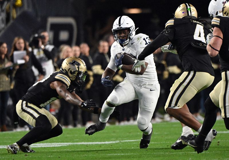 Nov 16, 2024; West Lafayette, Indiana, USA; Penn State Nittany Lions running back Kaytron Allen (13) runs into Purdue Boilermakers linebacker Kydran Jenkins (4) during the second half at Ross-Ade Stadium. Mandatory Credit: Marc Lebryk-Imagn Images