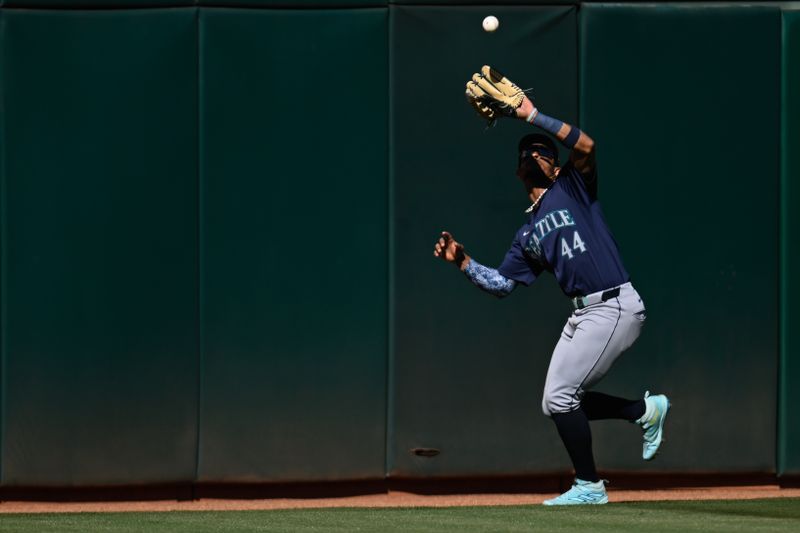 Sep 2, 2024; Oakland, California, USA; Seattle Mariners outfielder Julio Rodríguez (44) catches a fly ball hit by the Oakland Athletics in the first inning at Oakland-Alameda County Coliseum. Mandatory Credit: Eakin Howard-USA TODAY Sports