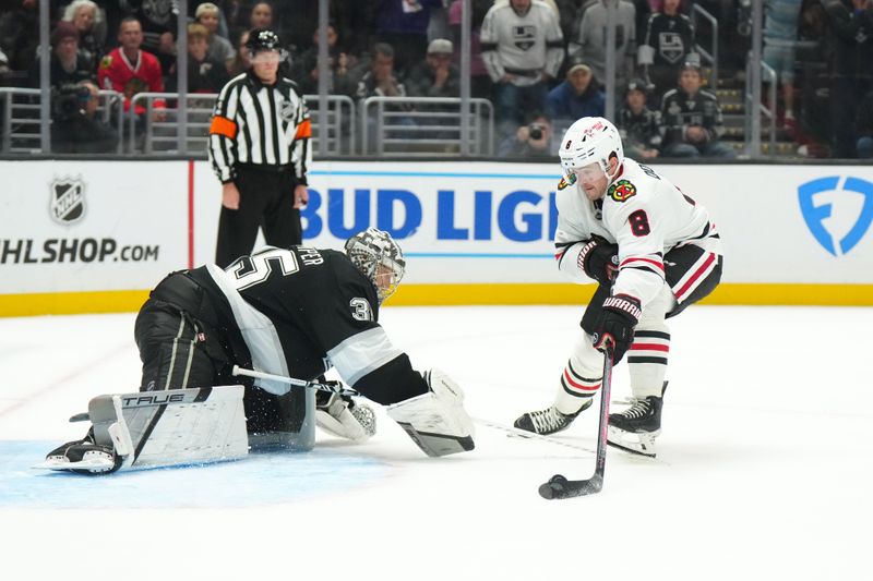 Nov 2, 2024; Los Angeles, California, USA; Chicago Blackhawks center Ryan Donato (8) shoots the puck against LA Kings goaltender Darcy Kuemper (35) for a goal in overtime at Crypto.com Arena. Mandatory Credit: Kirby Lee-Imagn Images