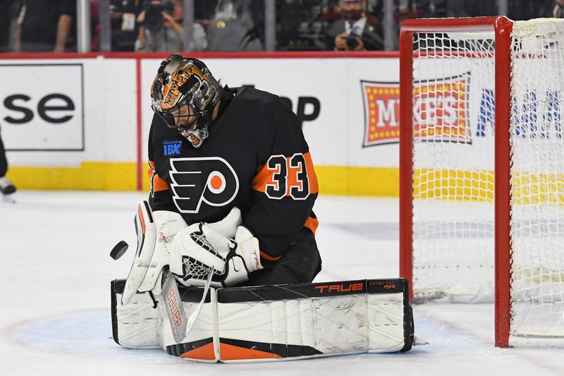 Jan 13, 2025; Philadelphia, Pennsylvania, USA; Philadelphia Flyers makes a save against the Florida Panthers during the second period at Wells Fargo Center. Mandatory Credit: Eric Hartline-Imagn Images
