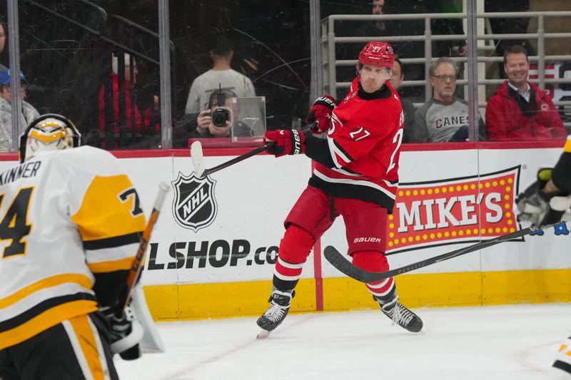 Mar 18, 2026; Raleigh, North Carolina, USA;  Carolina Hurricanes left wing Nikolaj Ehlers (27) takes a shot against the Pittsburgh Penguins during the first period at Lenovo Center. Mandatory Credit: James Guillory-Imagn Images