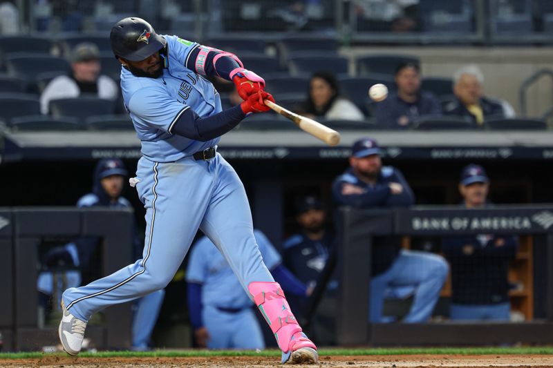 Apr 27, 2025; Bronx, New York, USA; Toronto Blue Jays first baseman Vladimir Guerrero Jr. (27) singles during the eighth inning against the New York Yankees at Yankee Stadium. Mandatory Credit: Vincent Carchietta-Imagn Images